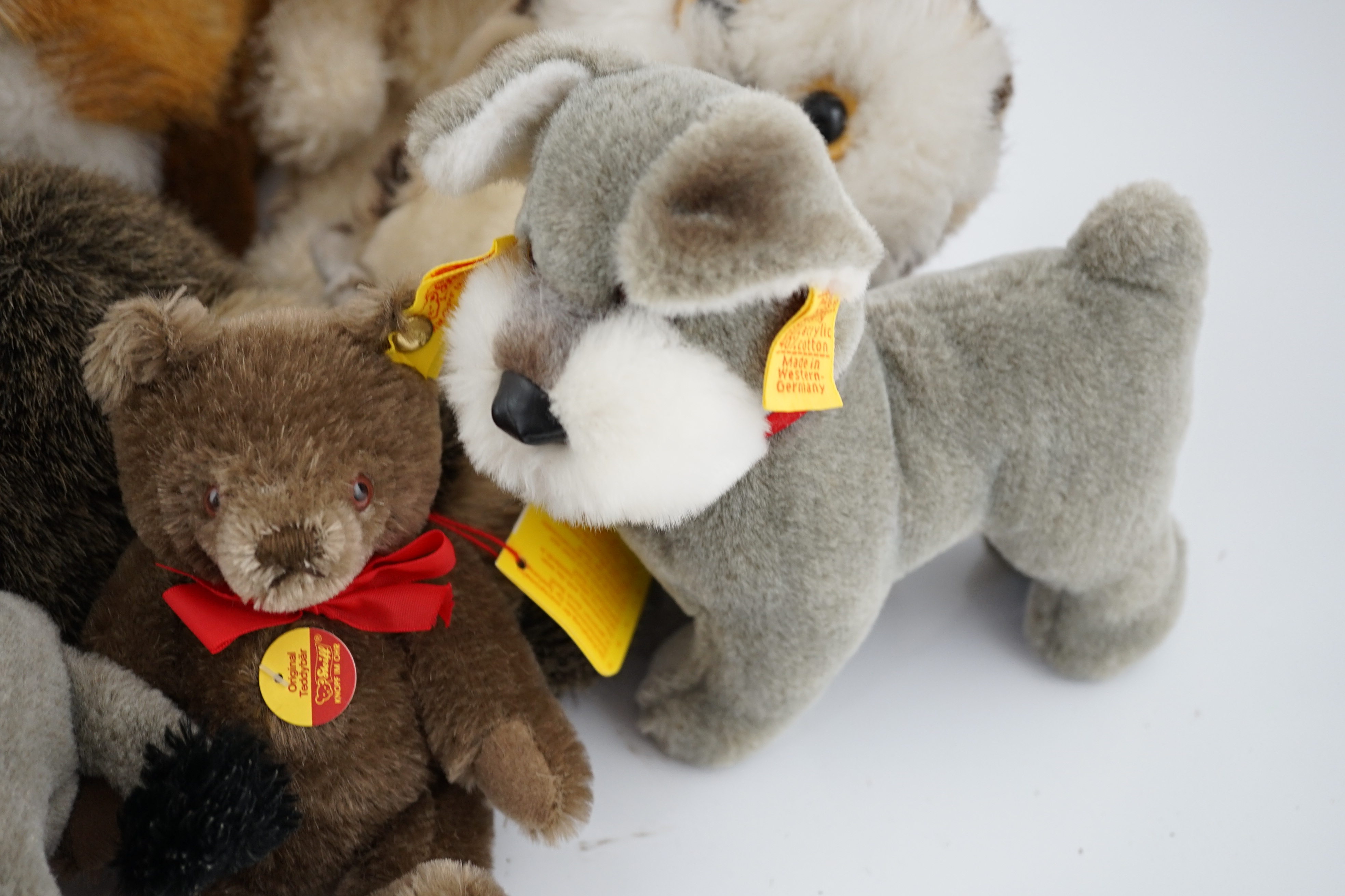 Nine assorted yellow tag Steiff animals, one Yorkshire Terrier, Steiff china plate, one yellow tag bear (12)